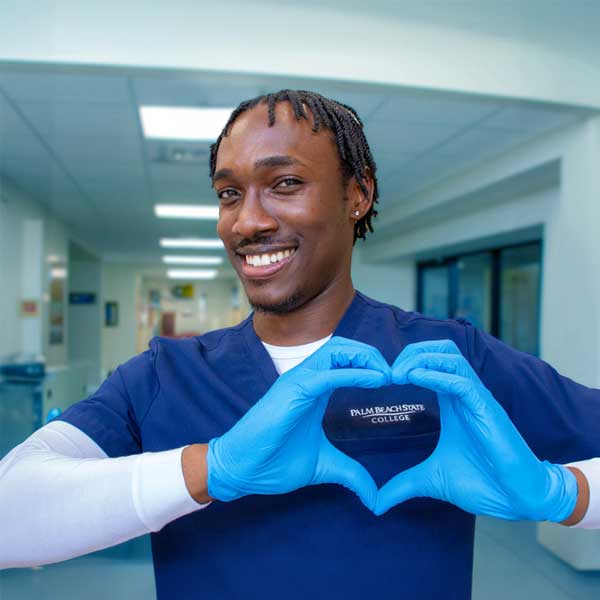 PBSC nursing student using his hands to make a heart